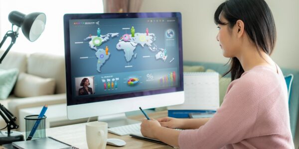 Woman attending virtual meeting - looking at graphics on screen