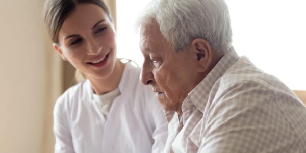 elderly patient with woman in white coat