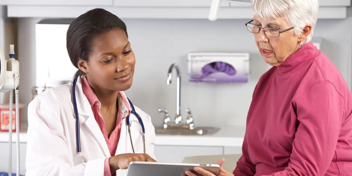 doctor and patient looking at a tablet screen