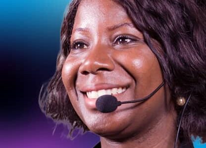 smiling woman, wearing microphone headset