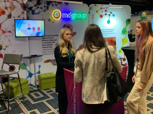 mdgroup team talking to visitors at the booth at ACRP