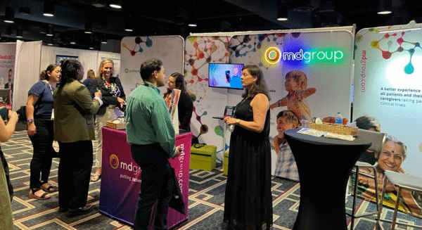 mdgroup team talking to visitors at the booth at ACRP