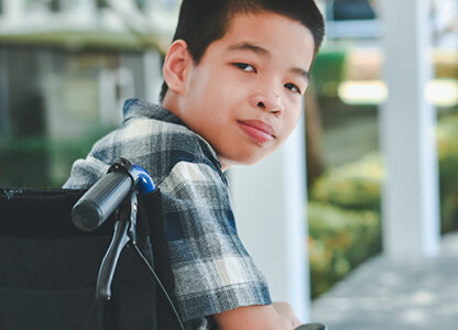 Boy in a wheelchair looking back over his shoulder
